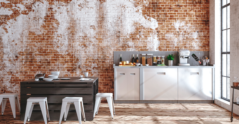 <strong>Styl Industrialny.</strong> Surowość i prostota to główne cechy tego stylu. Przede wszystkim styl industrialny rezygnuje z klasycznego podziału pomieszczeń. W fabrykach i halach produkcyjnych nie ma ścian działowych, dlatego mieszkania w stylu industrialnym często również z nich rezygnują. Zamiast ścianek działowych mieszkania industrialne wykorzystują meble, półki, i inne elementy wyposażenia do odgrodzenia od siebie strefy jadalnej, sypialnianej i wypoczynkowej. Styl industrialny chętnie korzysta z takich materiałów jak surowa cegła, beton, drewno czy metal. Meble industrialne również są proste i minimalistyczne. zdjęcie